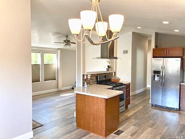 a kitchen with a sink a refrigerator and a stove