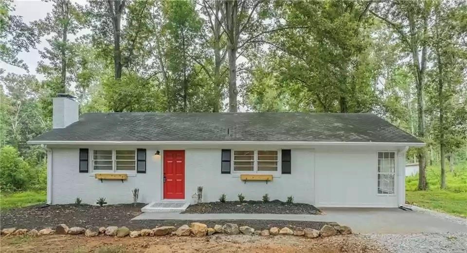 1076 Bolton Gordon Road Commerce, GA 30530 - Photo 1 of 1 a front view of a house with a yard and garage