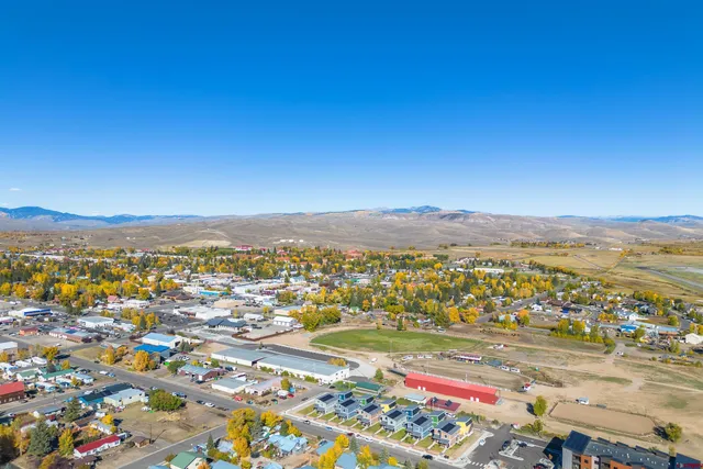a view of a patio with table and chairs under an umbrella