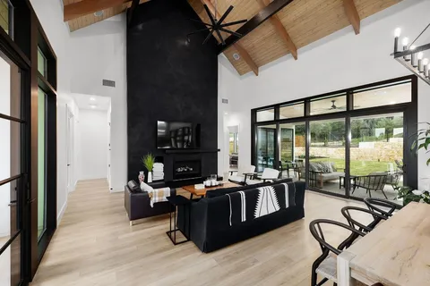 a view of a livingroom with furniture and floor to ceiling window