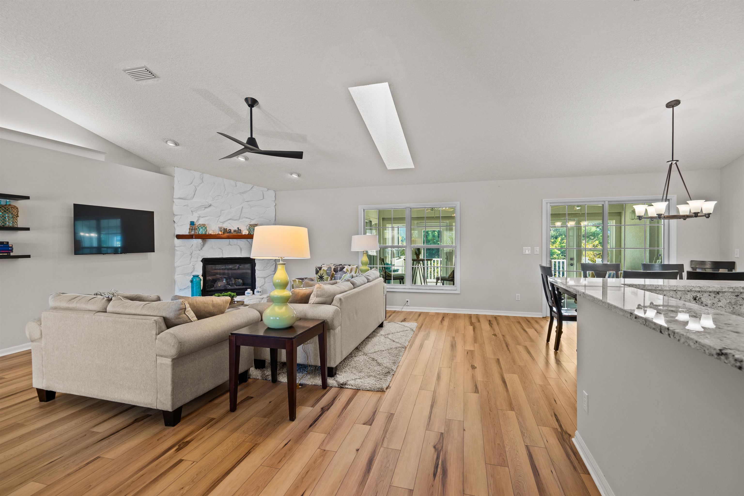 21 Ocean Trace Road St. Augustine, FL 32080 - Photo 18 of 48 a living room with furniture a fireplace and a flat screen tv