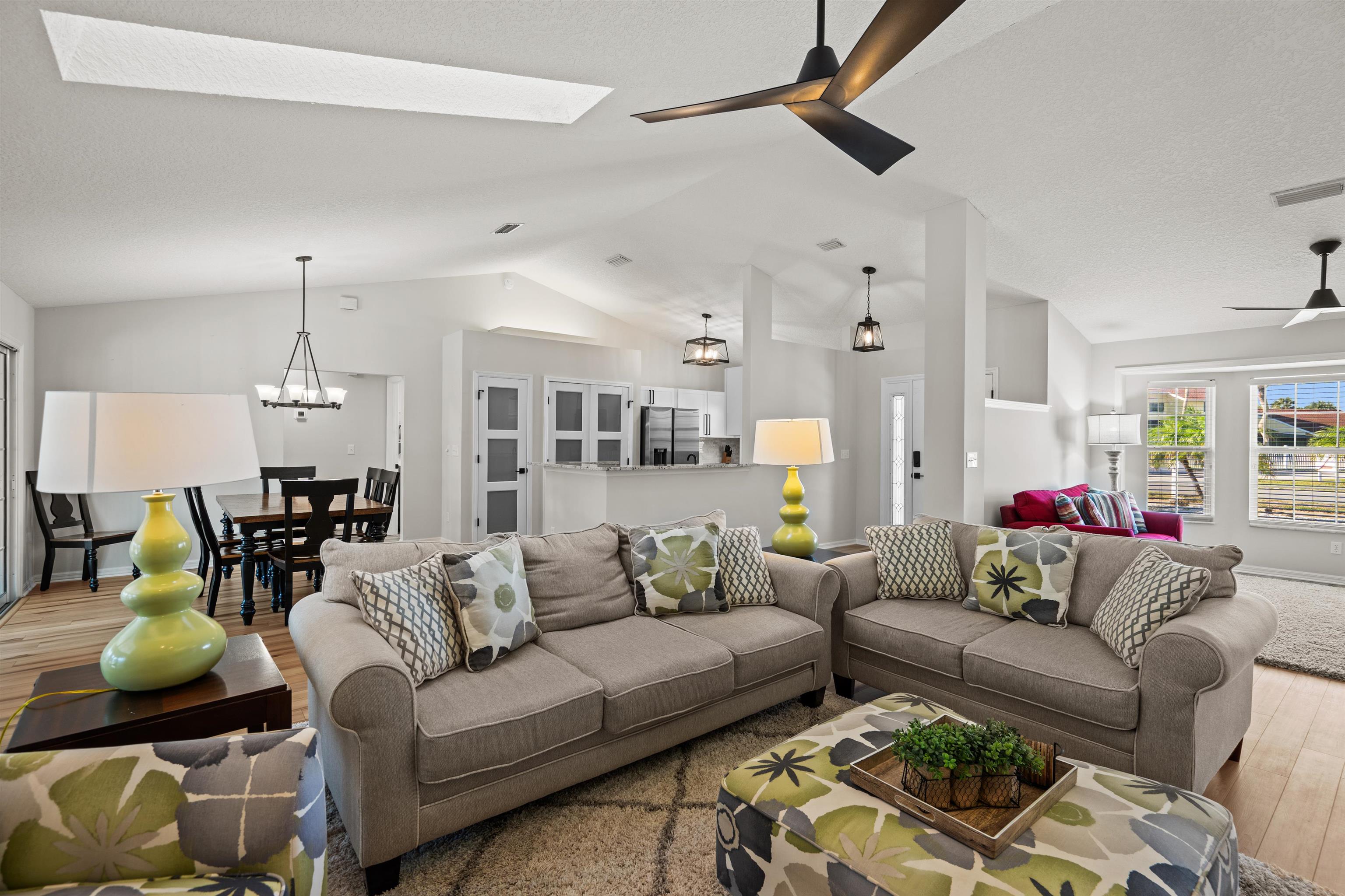 21 Ocean Trace Road St. Augustine, FL 32080 - Photo 2 of 48 a living room with furniture kitchen view and a chandelier
