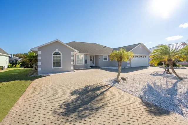 a living room with furniture kitchen view and a chandelier