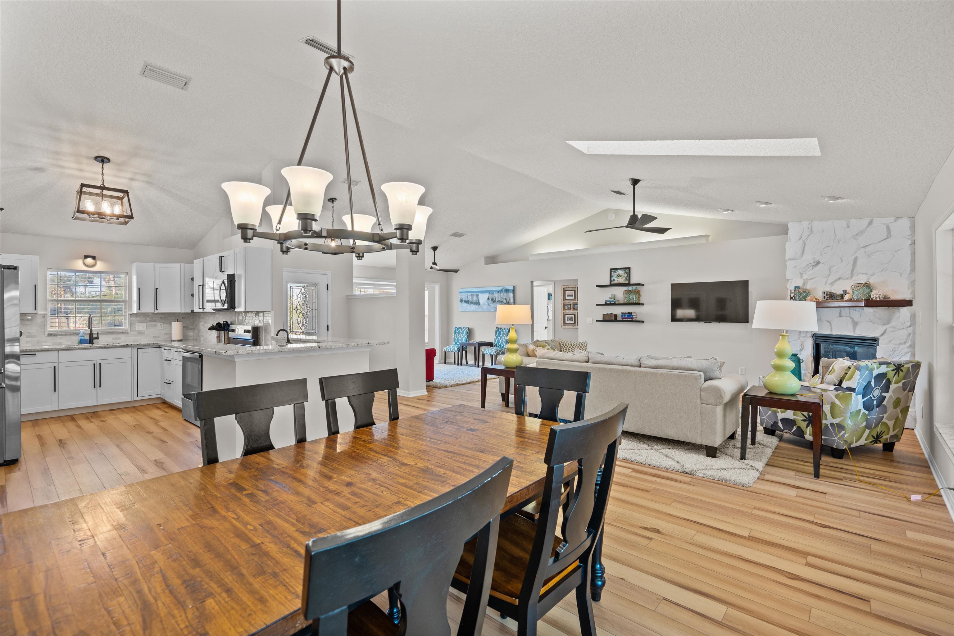 21 Ocean Trace Road St. Augustine, FL 32080 - Photo 24 of 48 a view of a dining room and livingroom with furniture wooden floor a chandelier