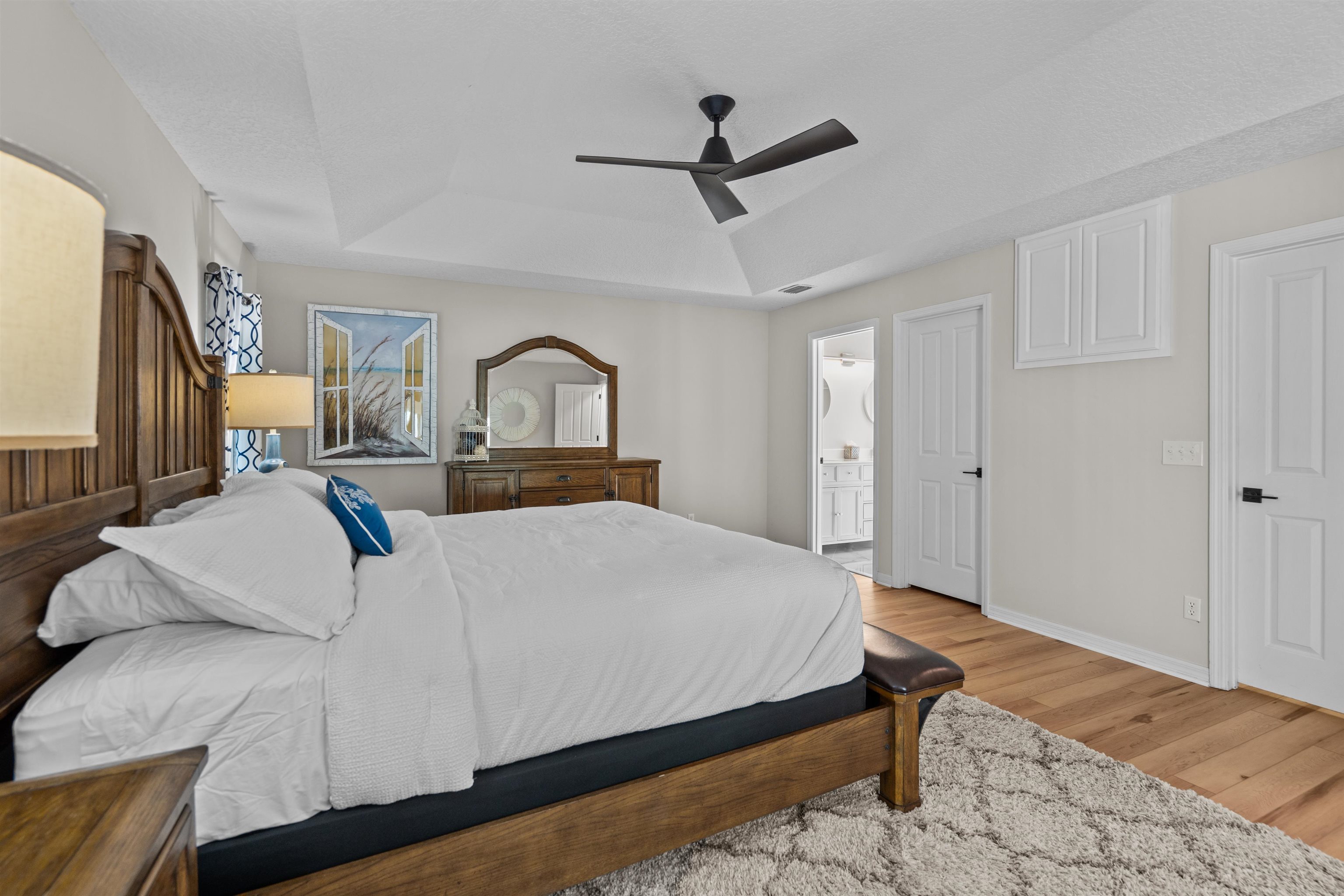21 Ocean Trace Road St. Augustine, FL 32080 - Photo 29 of 48 a bedroom with a bed ceiling fan and a wooden floor