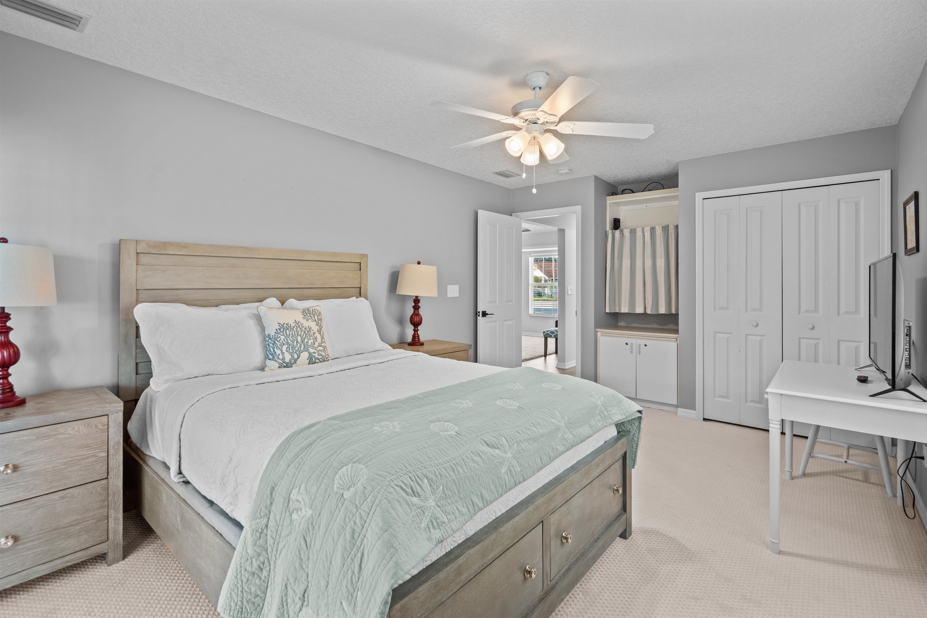21 Ocean Trace Road St. Augustine, FL 32080 - Photo 38 of 48 a spacious bedroom with a bed and a chandelier