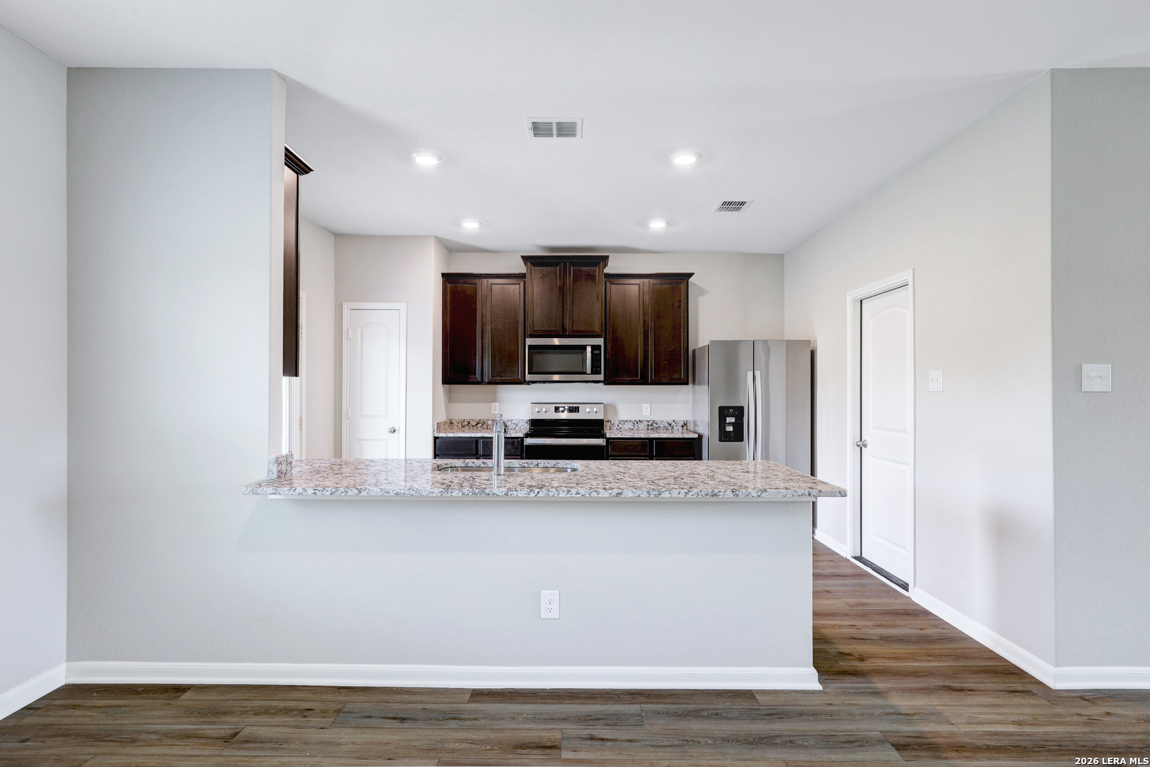 6403 Warhol Cape Converse, TX 78109 - Photo 11 of 29 a large kitchen with stainless steel appliances a large counter top and a stove top oven