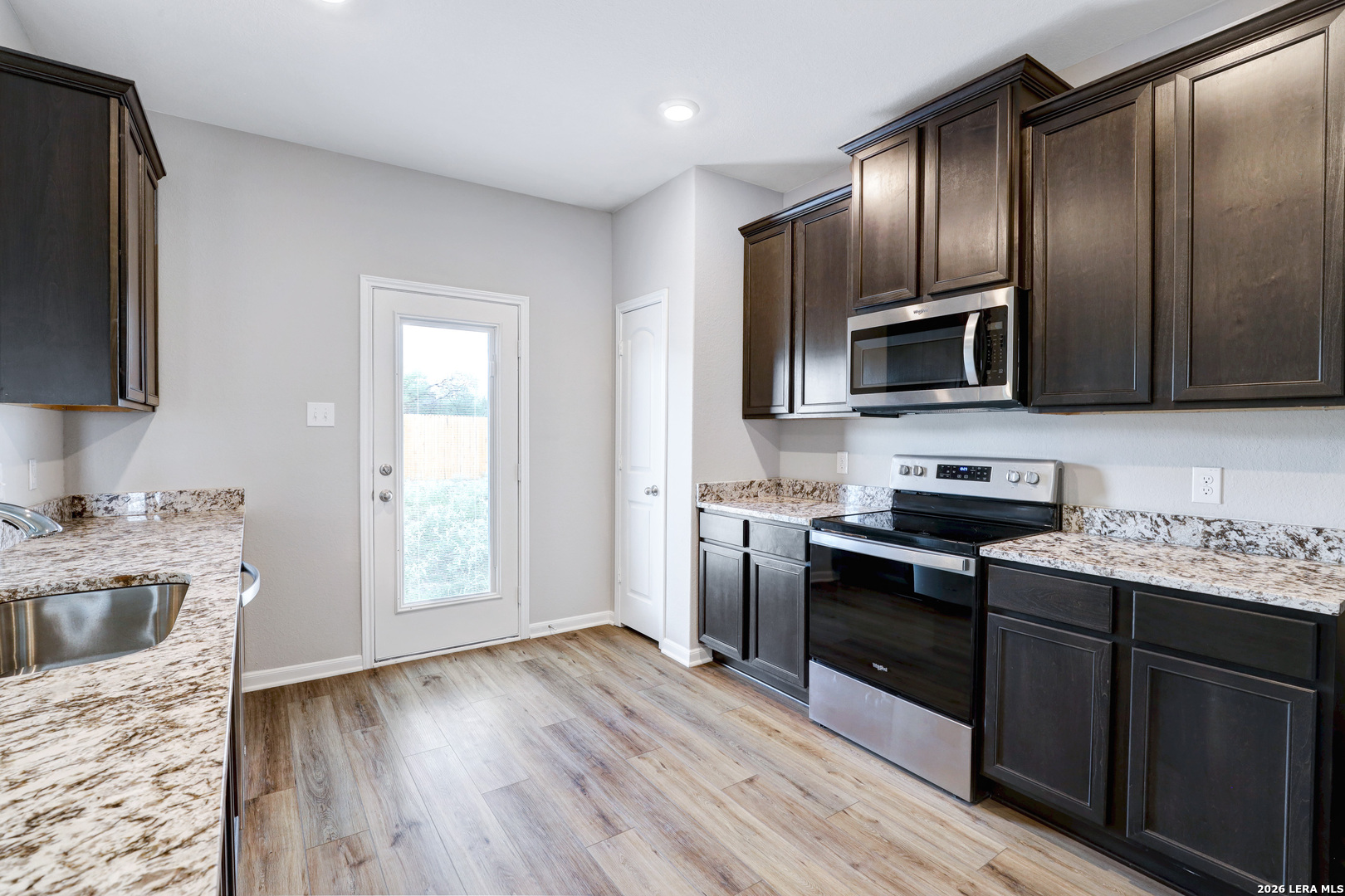 6403 Warhol Cape Converse, TX 78109 - Photo 12 of 29 a kitchen with a sink stove top oven and refrigerator