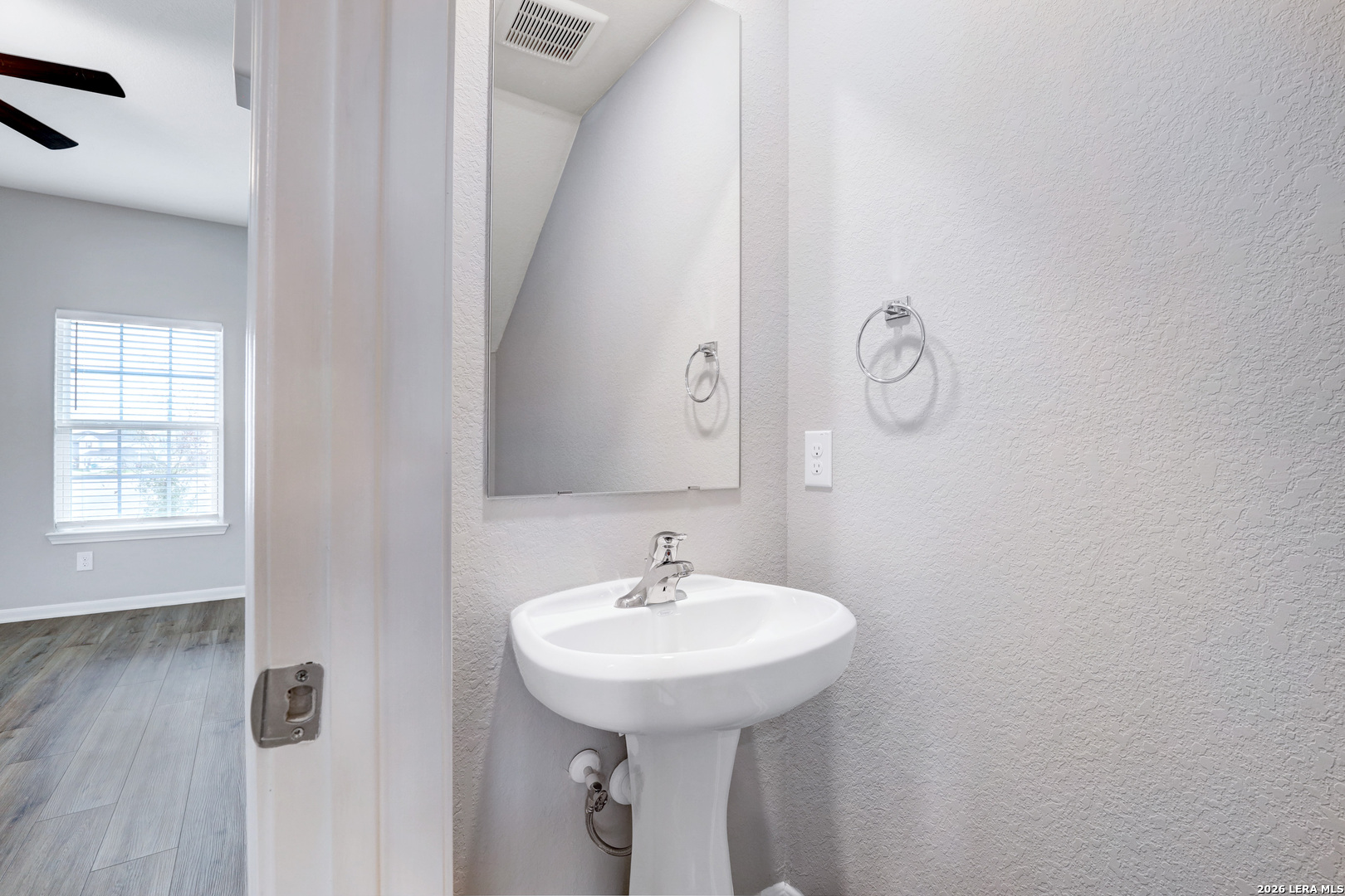 6403 Warhol Cape Converse, TX 78109 - Photo 16 of 29 a bathroom with a sink and a mirror