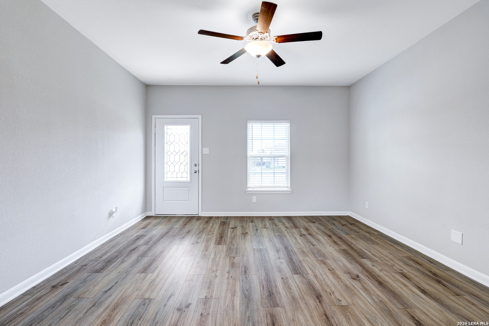 6403 Warhol Cape Converse, TX 78109 - Photo 2 of 29 wooden floor in an empty room with a window