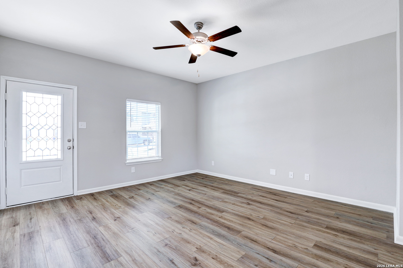 6403 Warhol Cape Converse, TX 78109 - Photo 3 of 29 an empty room with wooden floor and windows