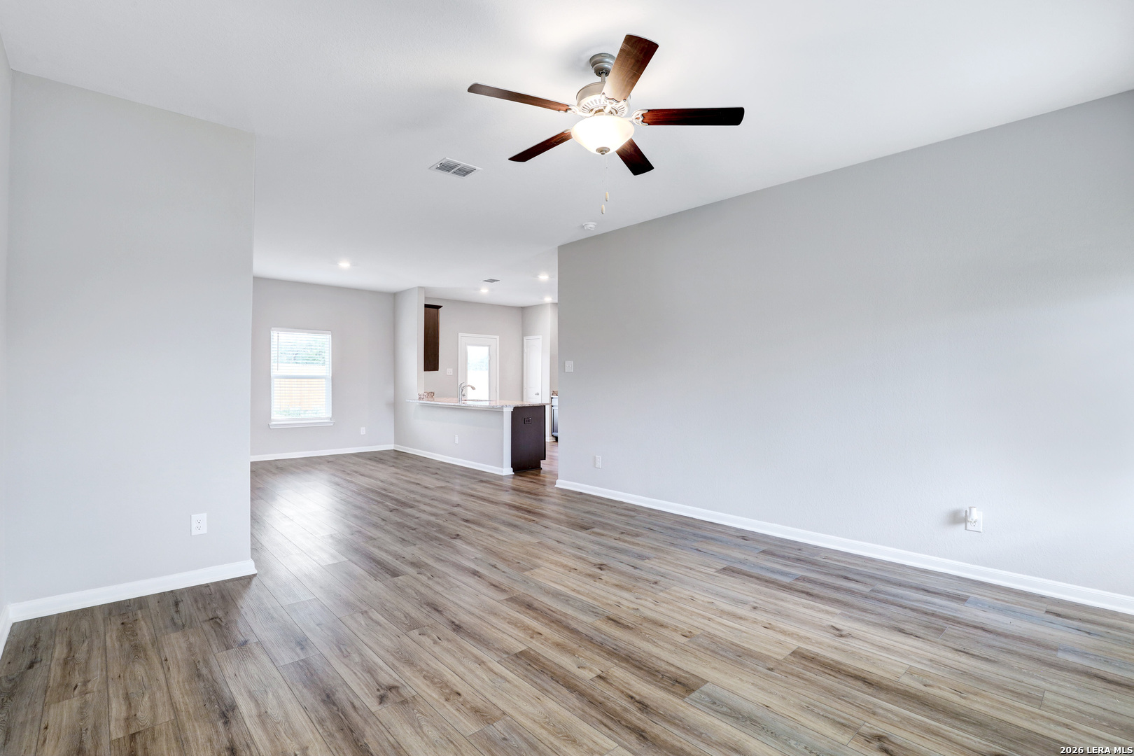 6403 Warhol Cape Converse, TX 78109 - Photo 6 of 29 a view of empty room with wooden floor and ceiling fan