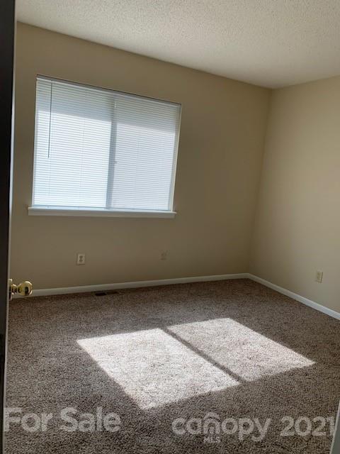 6605 Piney Path Road Charlotte, NC 28212 - Photo 8 of 21 an empty room with a window