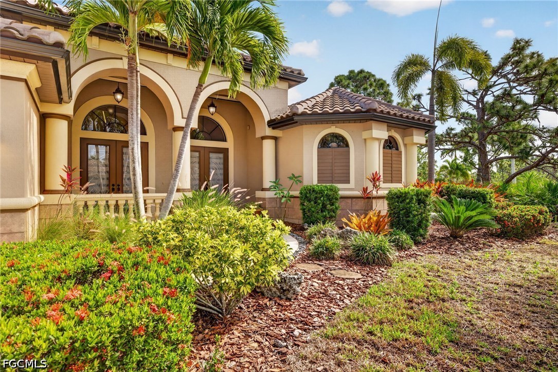 6109 Calusa Rdg Trail Bokeelia, FL 33922 - Photo 5 of 48 front view of a house with a garden