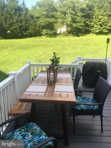 a view of a ocean from a balcony with furniture