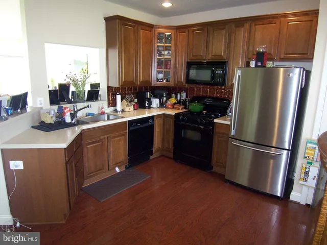 a kitchen with a refrigerator stove and sink