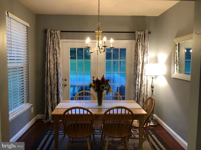 a view of a dining room with furniture and chandelier