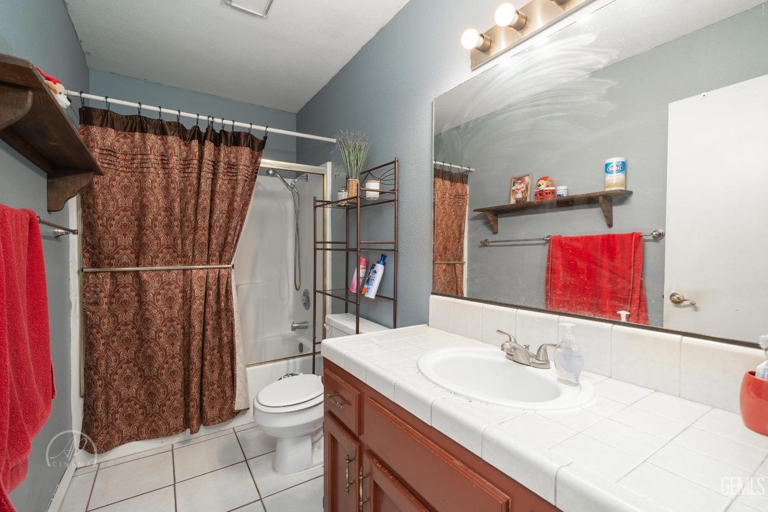 Undisclosed Address Bakersfield, CA 93307 - Photo 11 of 19 a bathroom with a sink toilet and shower
