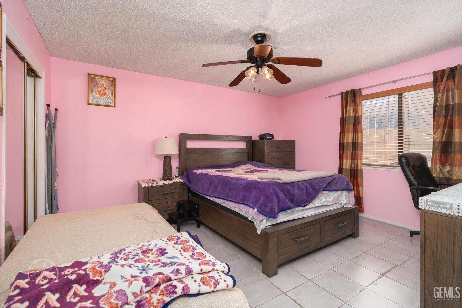 Undisclosed Address Bakersfield, CA 93307 - Photo 12 of 19 a bedroom with a bed and wooden floor