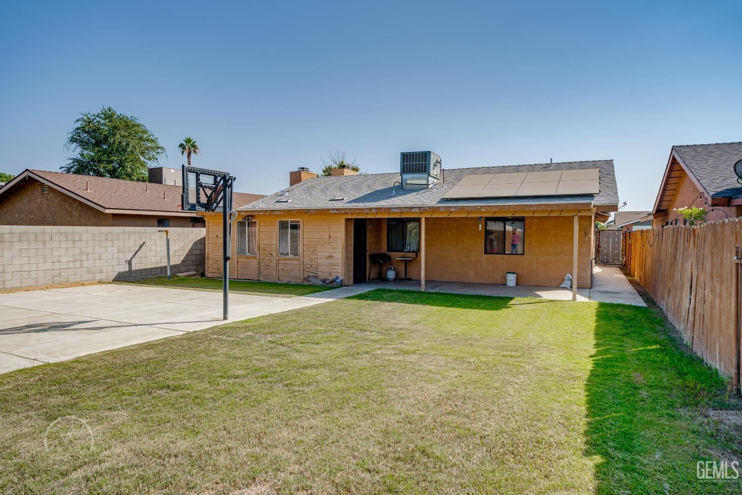 Undisclosed Address Bakersfield, CA 93307 - Photo 2 of 19 a front view of a house with a yard and garage