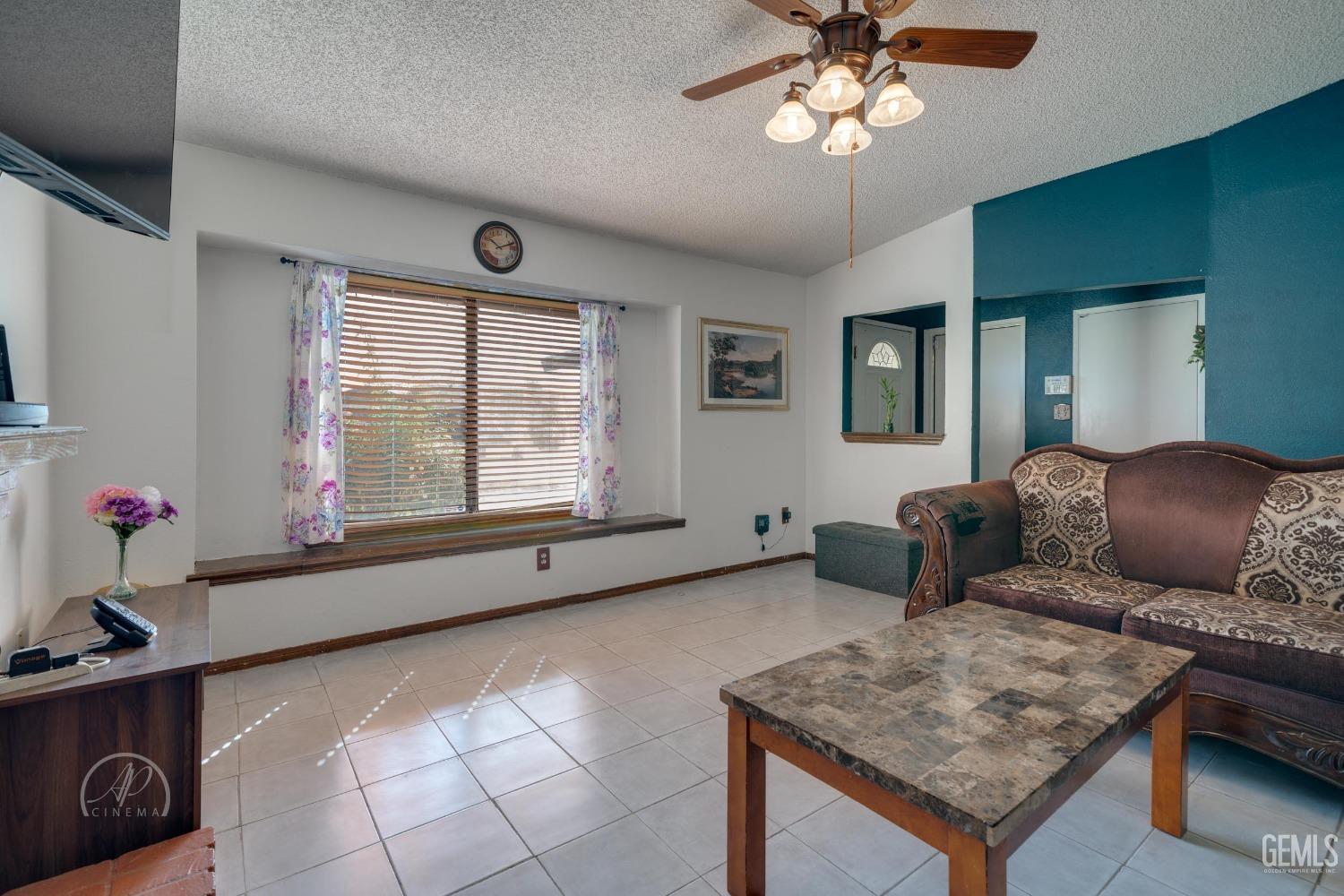 Undisclosed Address Bakersfield, CA 93307 - Photo 5 of 19 a living room with furniture and a window