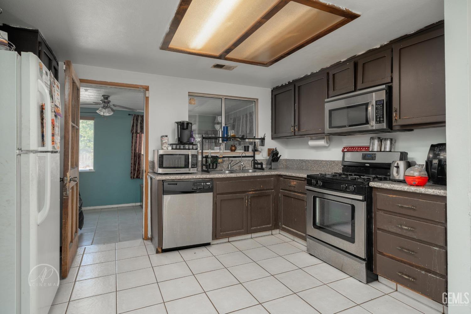 Undisclosed Address Bakersfield, CA 93307 - Photo 6 of 19 a kitchen with a sink and steel appliances