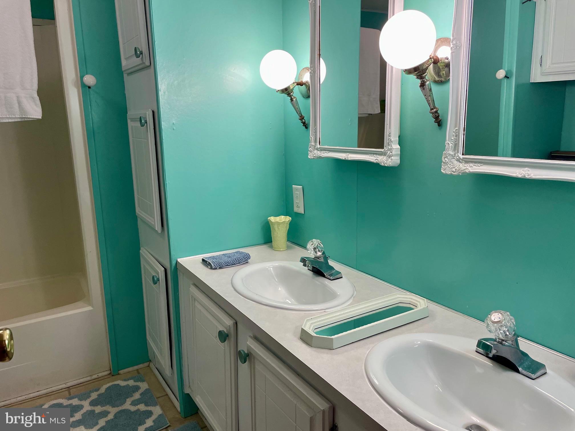 31627 Reading Street Ocean View, DE 19970 - Photo 12 of 21 a bathroom with a sink and a mirror