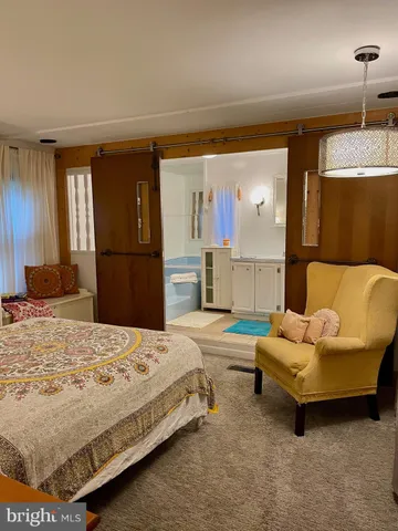 a bedroom with a bed and a couch