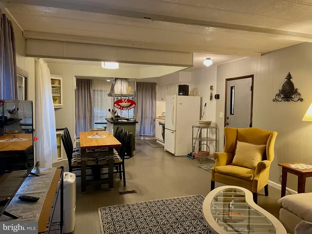 a living room with furniture a flat screen tv and a table