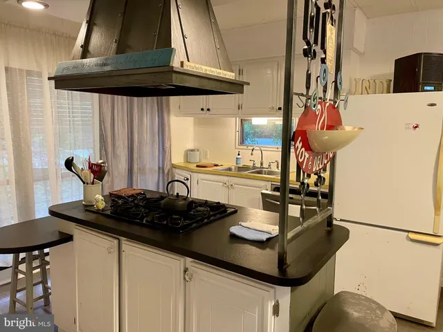 a kitchen with stainless steel appliances kitchen island granite countertop a sink and cabinets