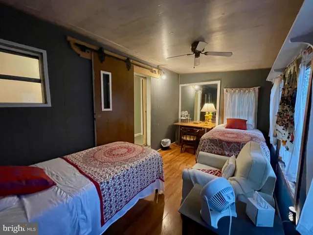 a bedroom with a bed couch and a window