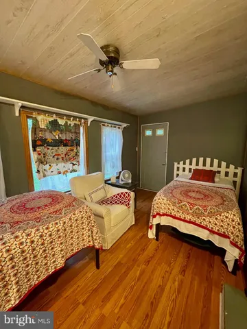a bedroom with a bed and a painting on the wall