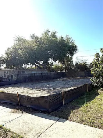 a view of a roof deck with outdoor seating and trees in the background