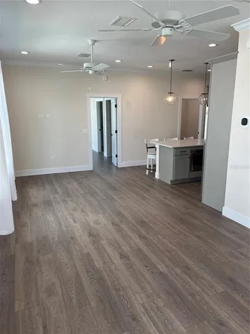 an empty room with wooden floor and entrance