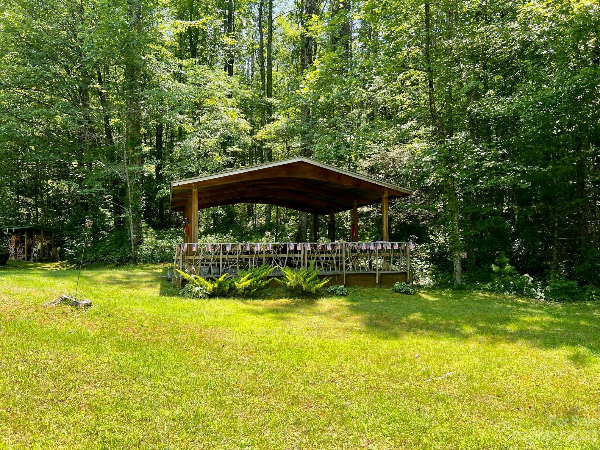 Lot 24 Round Mountain Road, Unit 24 Brevard, NC 28712 - Photo 16 of 22 a view of swimming pool with lawn chairs under an umbrella