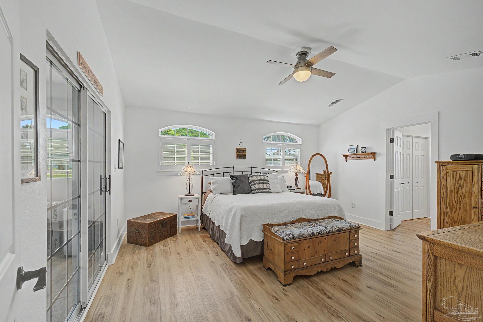 2005 Riviera Lane South Navarre, FL 32566 - Photo 18 of 70 a bedroom with a bed and a chandelier