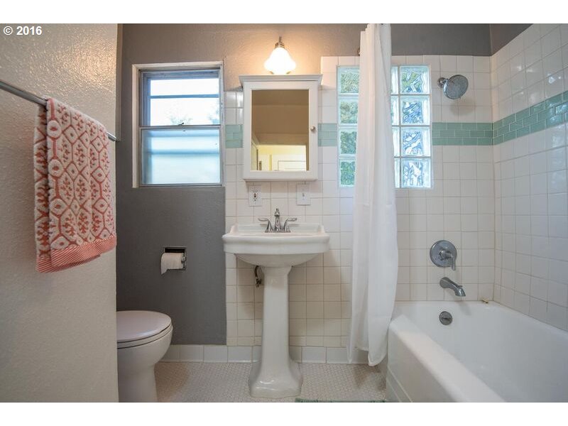 6026 Southwest Vermont Street Portland, OR 97219 - Photo 12 of 24 a bathroom with a sink a toilet and a bathtub