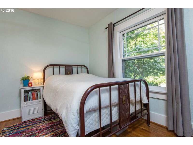 6026 Southwest Vermont Street Portland, OR 97219 - Photo 14 of 24 a bedroom with a bed and a large window