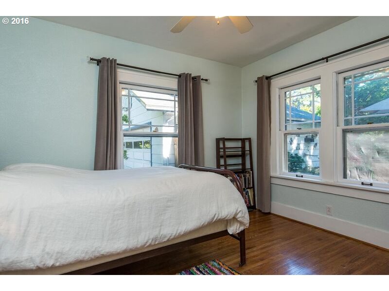 6026 Southwest Vermont Street Portland, OR 97219 - Photo 15 of 24 a bedroom with a bed and wooden floor