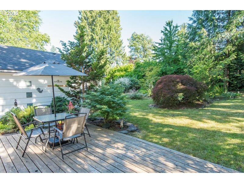6026 Southwest Vermont Street Portland, OR 97219 - Photo 20 of 24 a backyard of a house with table and chairs