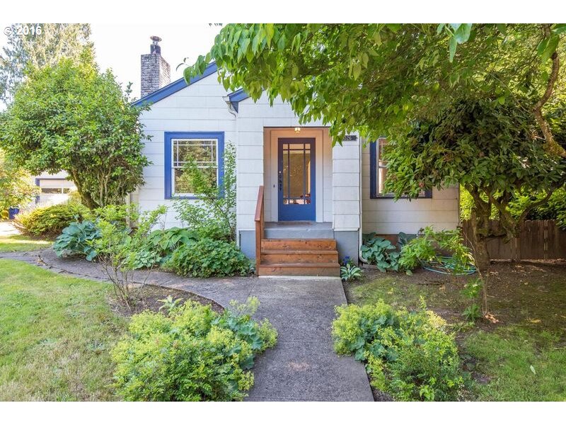 6026 Southwest Vermont Street Portland, OR 97219 - Photo 2 of 24 a front view of a house with garden