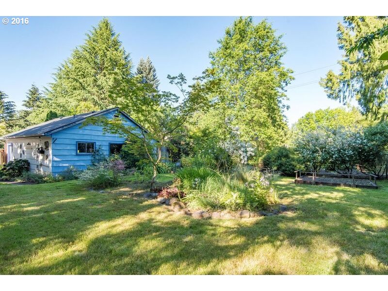 6026 Southwest Vermont Street Portland, OR 97219 - Photo 22 of 24 a backyard of a house with lots of green space