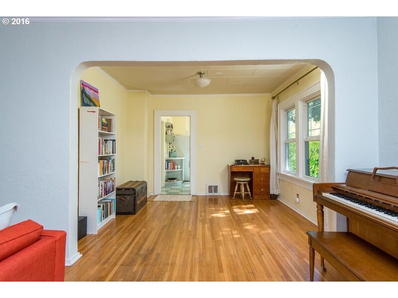 6026 Southwest Vermont Street Portland, OR 97219 - Photo 8 of 24 a living room with a couch and piano table