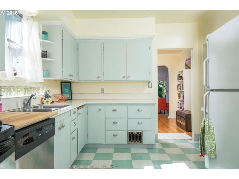 6026 Southwest Vermont Street Portland, OR 97219 - Photo 10 of 24 a kitchen with a refrigerator sink and cabinets