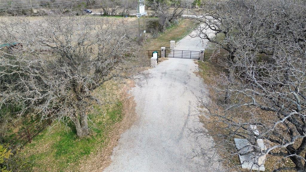 Lot 136 River Canyon Road Palo Pinto, TX 76484 - Photo 2 of 26 a view of a yard with plants and brick wall
