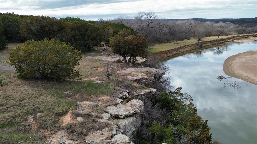 Lot 136 River Canyon Road Palo Pinto, TX 76484 - Photo 8 of 26 a view of a lake with a forest