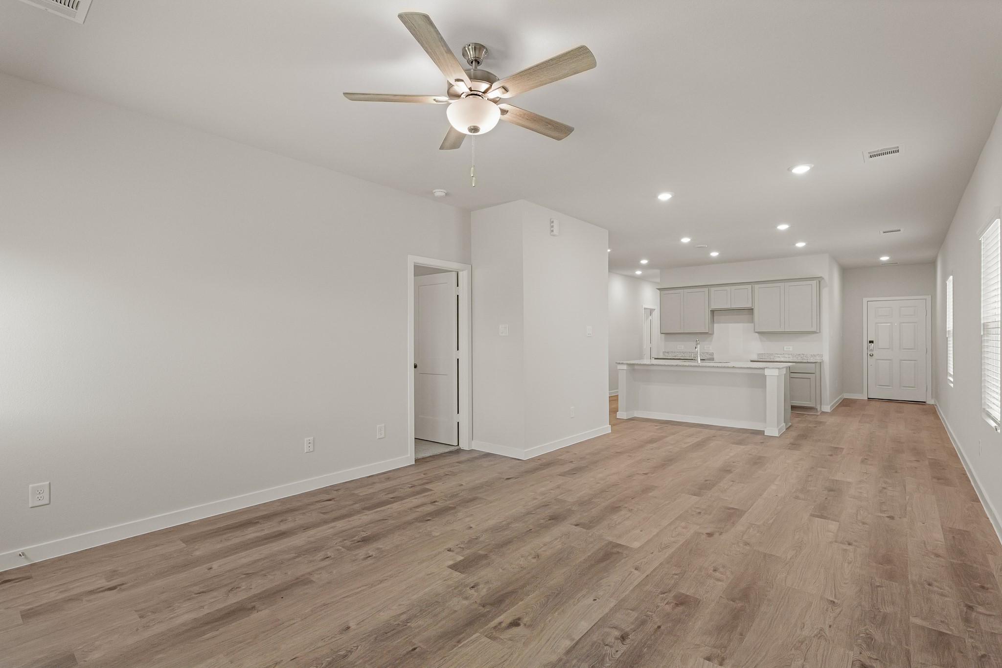 225 Spring Drive Hockley, TX 77447 - Photo 16 of 28 a view of an empty room with a kitchen