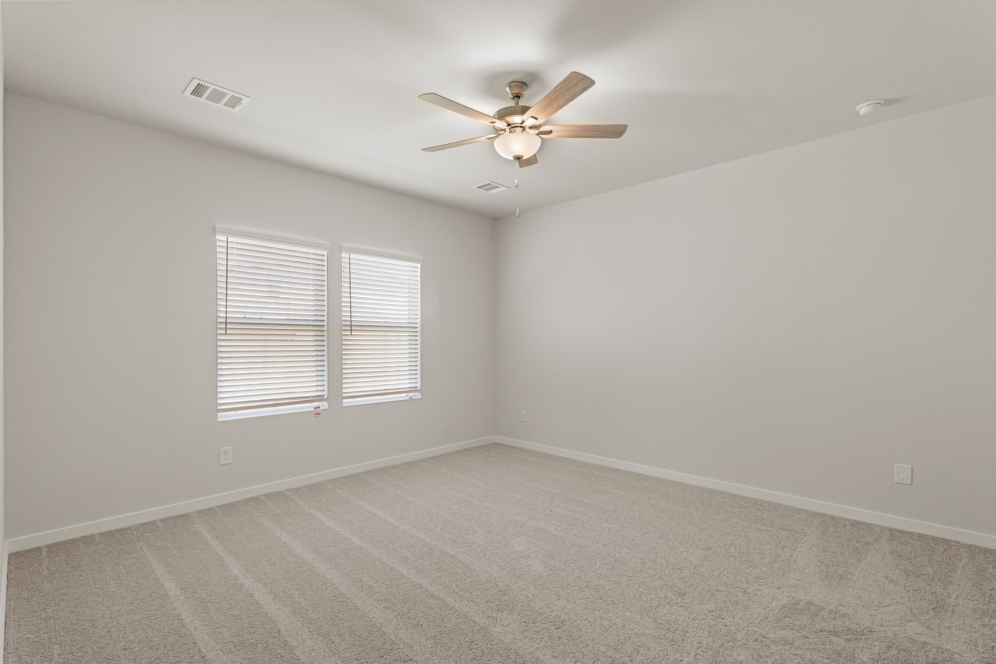 225 Spring Drive Hockley, TX 77447 - Photo 18 of 28 an empty room with a window and a fan