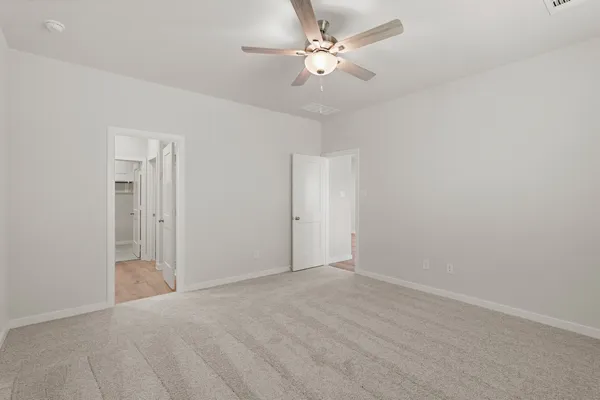 a view of an empty room with a ceiling fan