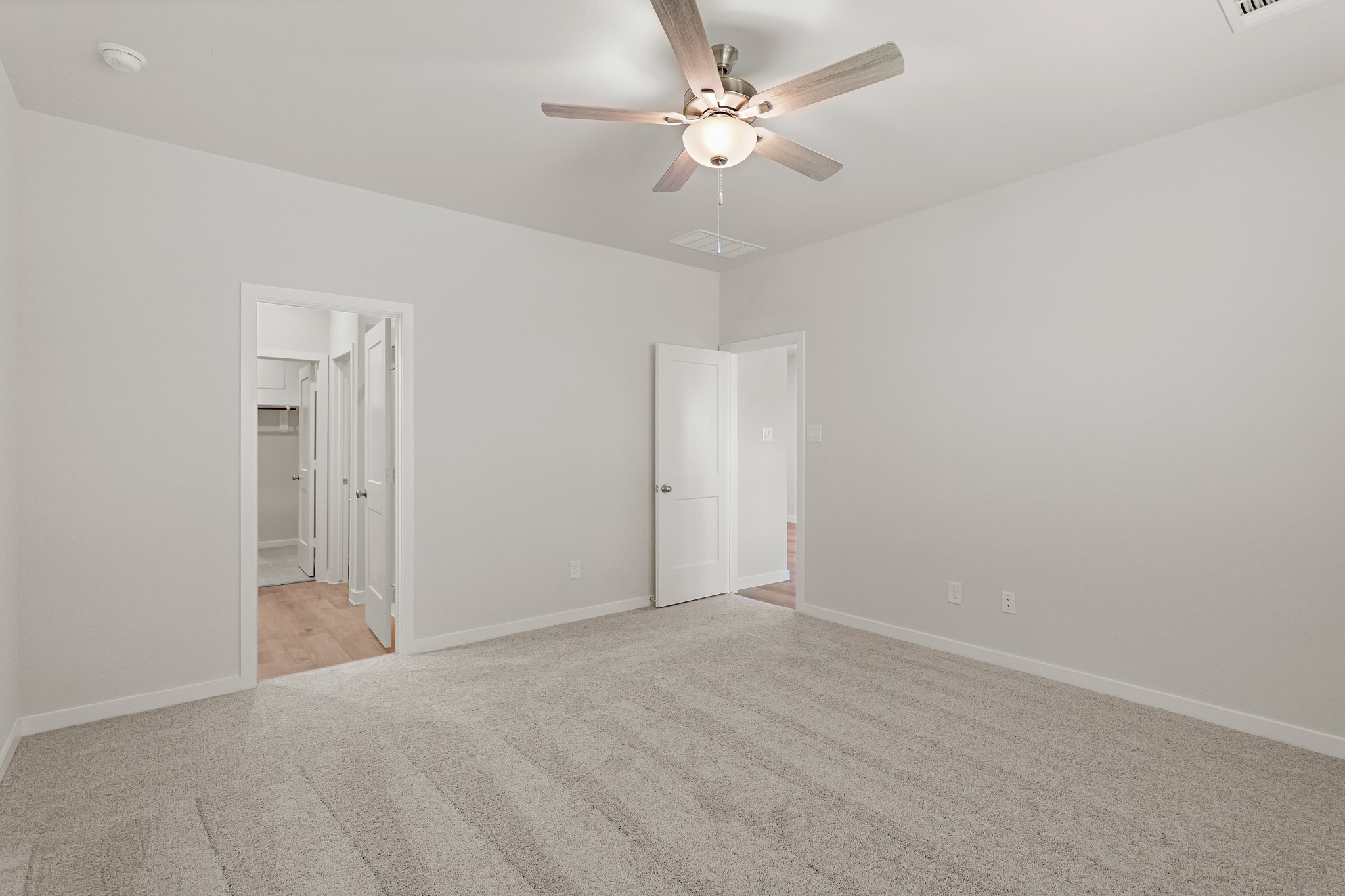 225 Spring Drive Hockley, TX 77447 - Photo 19 of 28 a view of an empty room with a ceiling fan